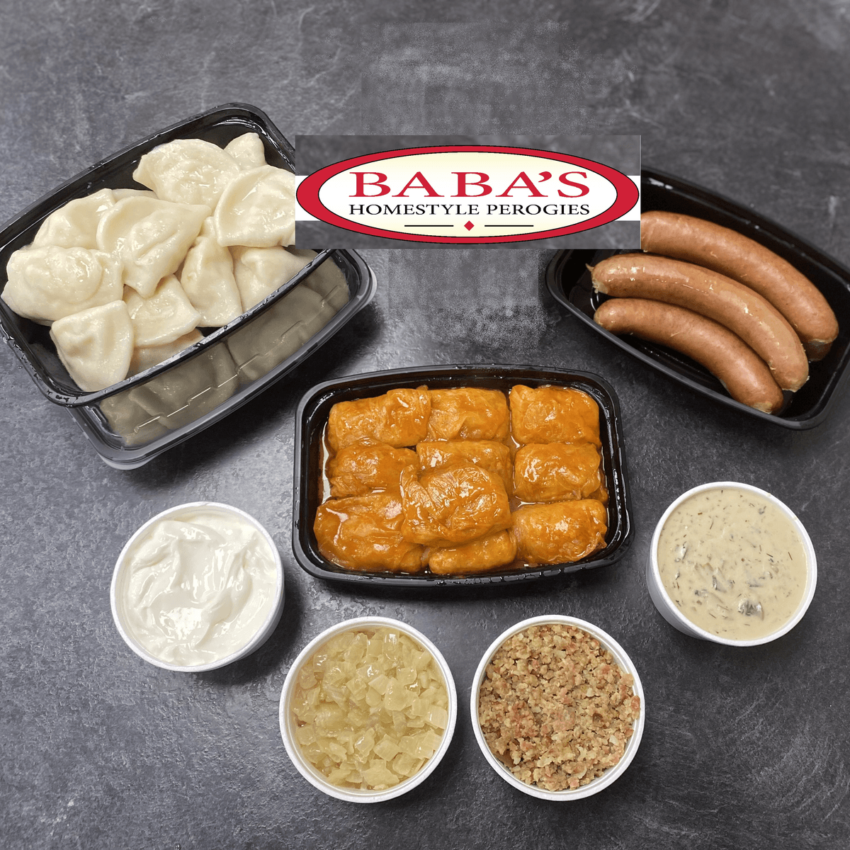 A Dinner for 5 laid out: perogies, cabbage rolls, smokies, sour cream, onions, bacon bits and mushroom dill sauce