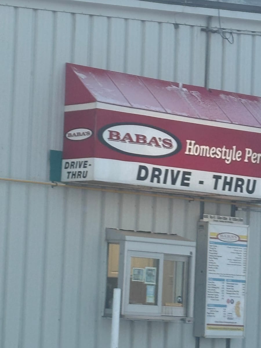 The Baba's drive-thru window and menu board under the red awning